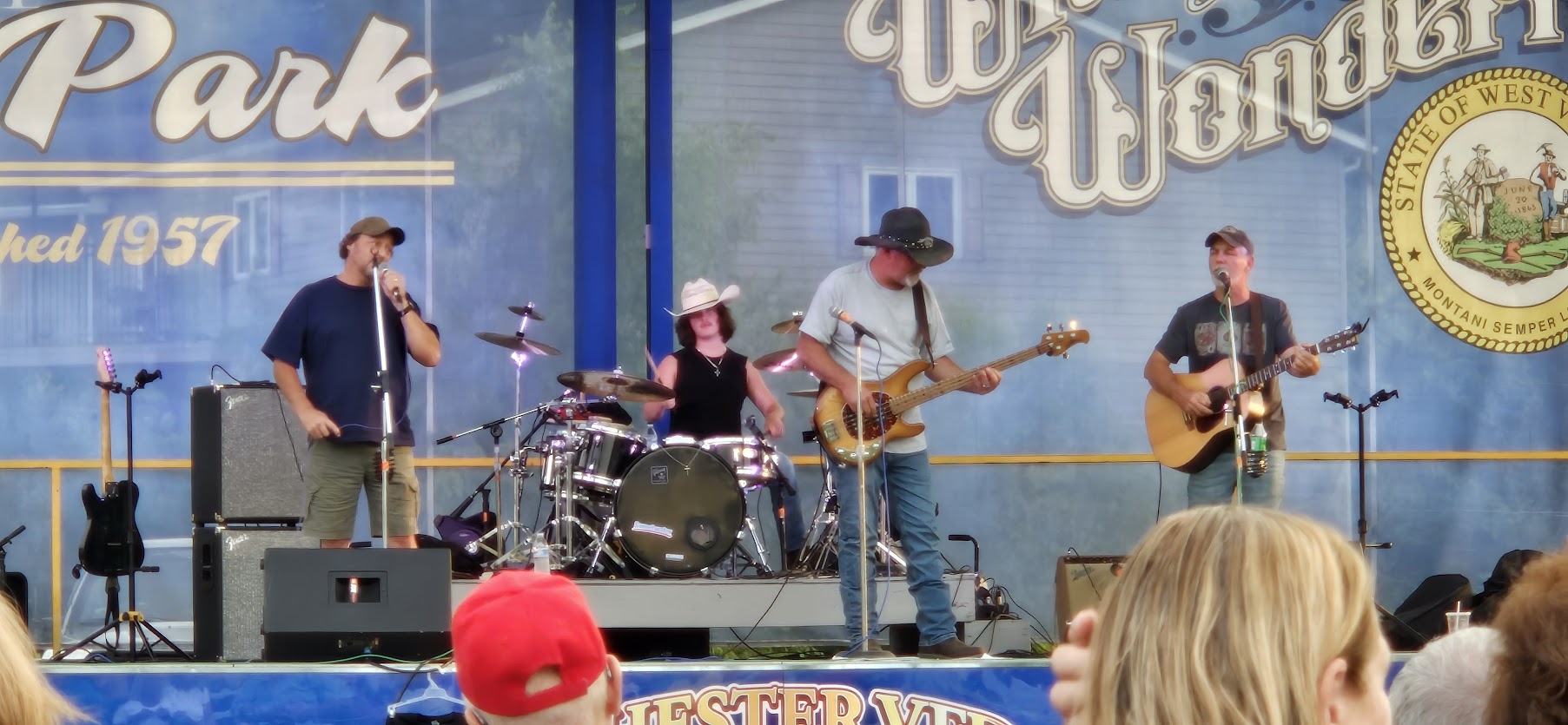 Tobe singing with the Wells Brothers band on the stage at Chester City Park.
